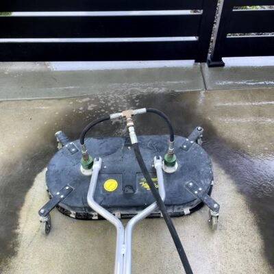 Surface cleaner pressure washing a concrete driveway in the Treasure Valley
