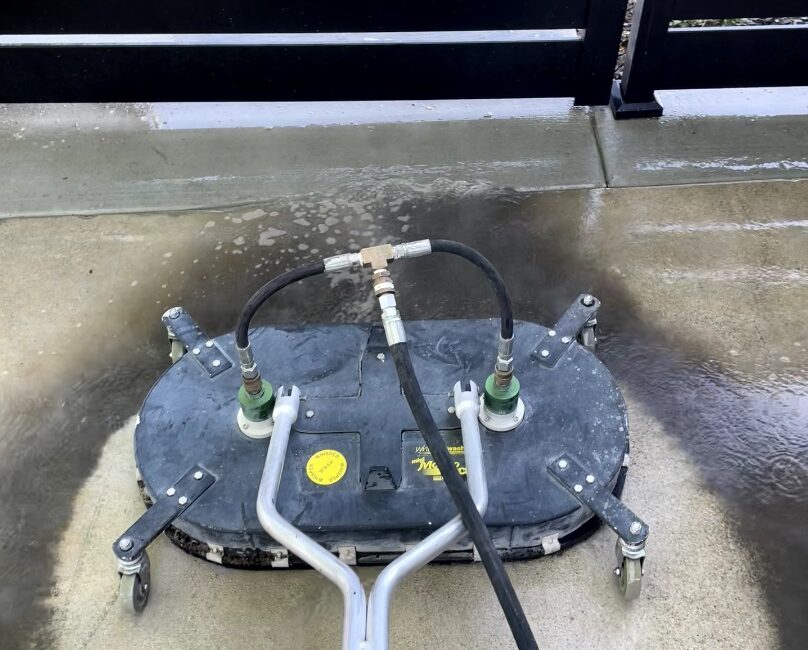 Surface cleaner pressure washing a concrete driveway in the Treasure Valley